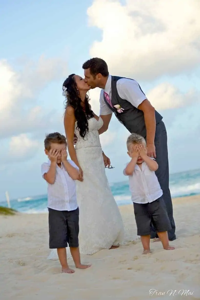 wedding kiss with kids covering eyes