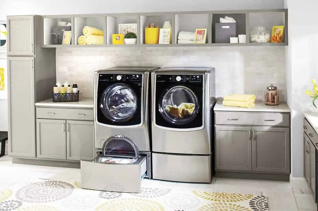 sleek LG appliances in a grey and yellow laundry room How To Remove Common Laundry Stains 