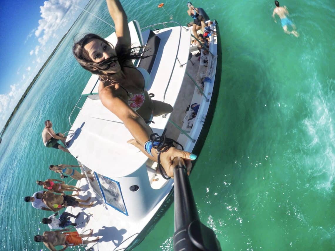 girl jumping off boat in ocean