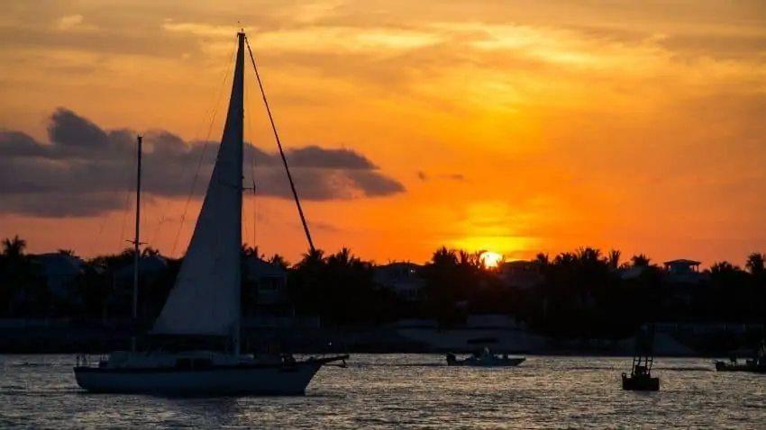 Key West Mallory Square sunset with sailboat on the water
