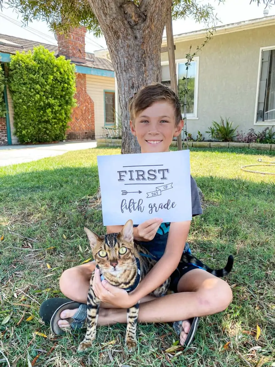smiling boy with  cat first day of school 5th grade