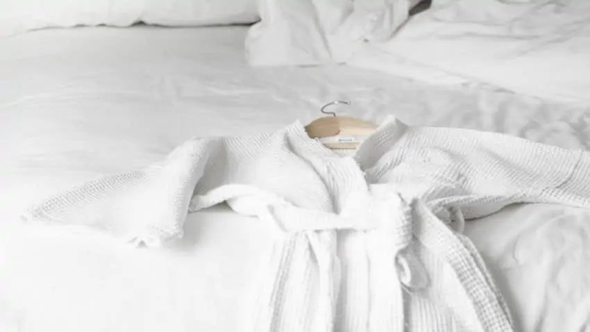 white bathrobe on a bed