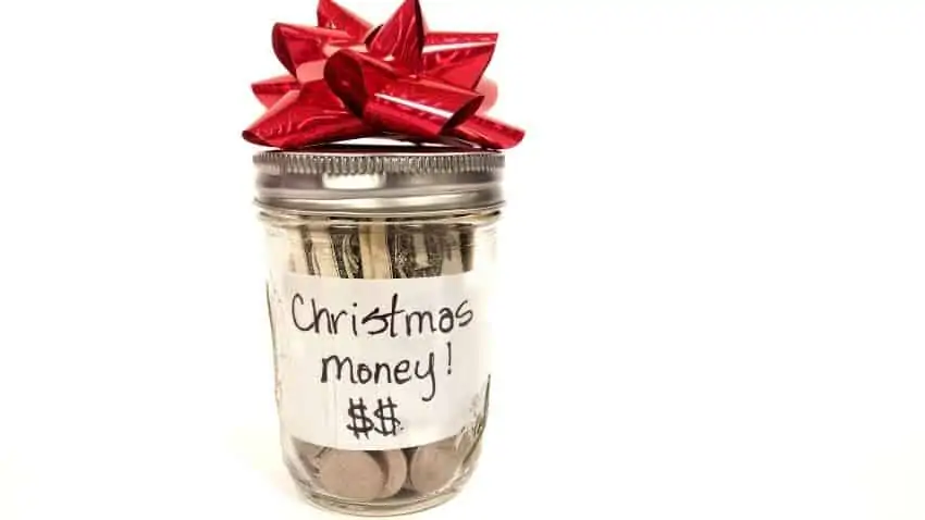 cash in a jar labeled christmas money
