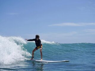 boy surfing in waikiki
