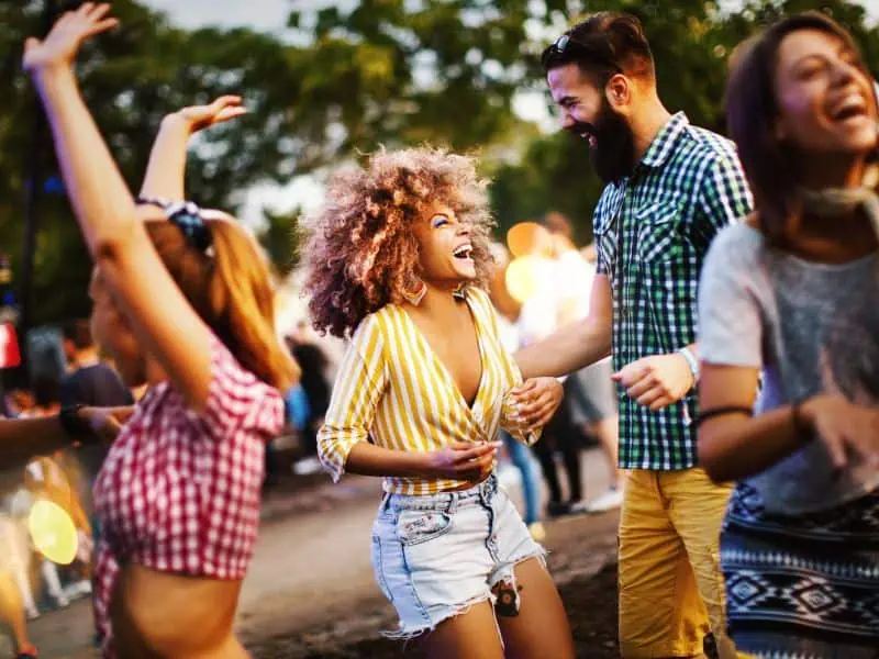 people laughing and dancing at a festival
