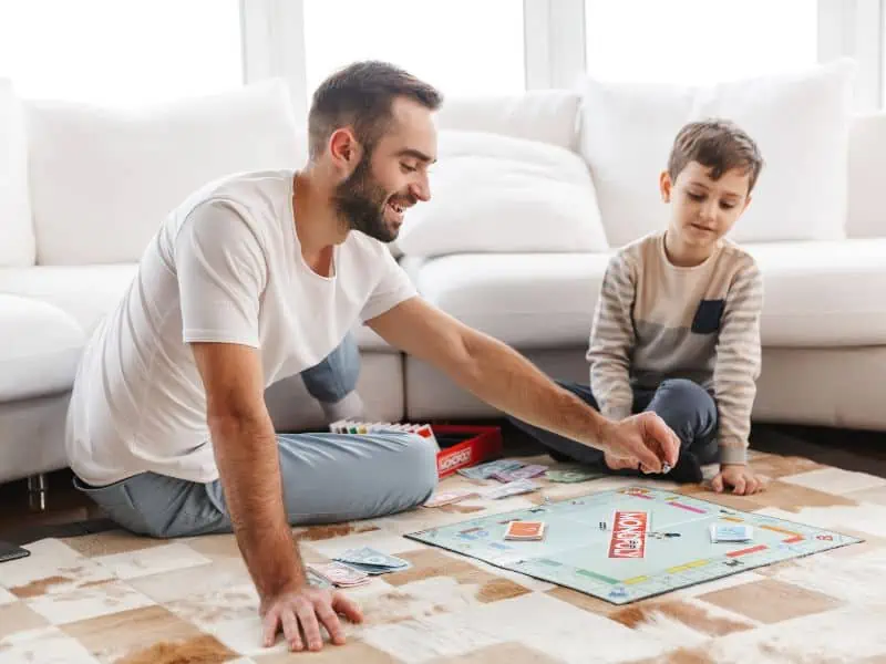 father playing monopoly with son